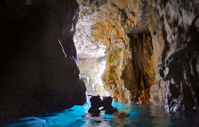 couple kissing in illuminated cave