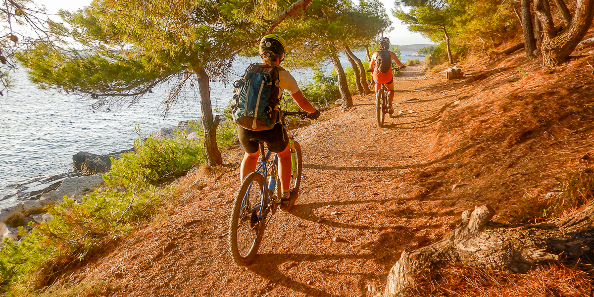 Couple riding bikes along the coastline.