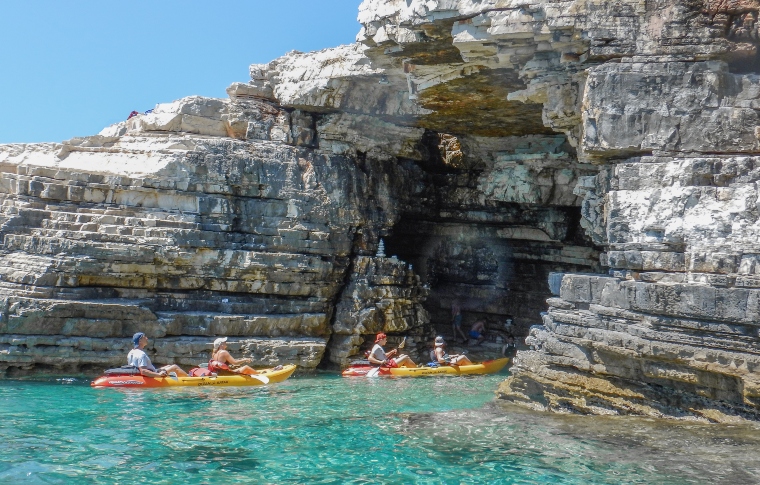 two kayaks in front of a cave
